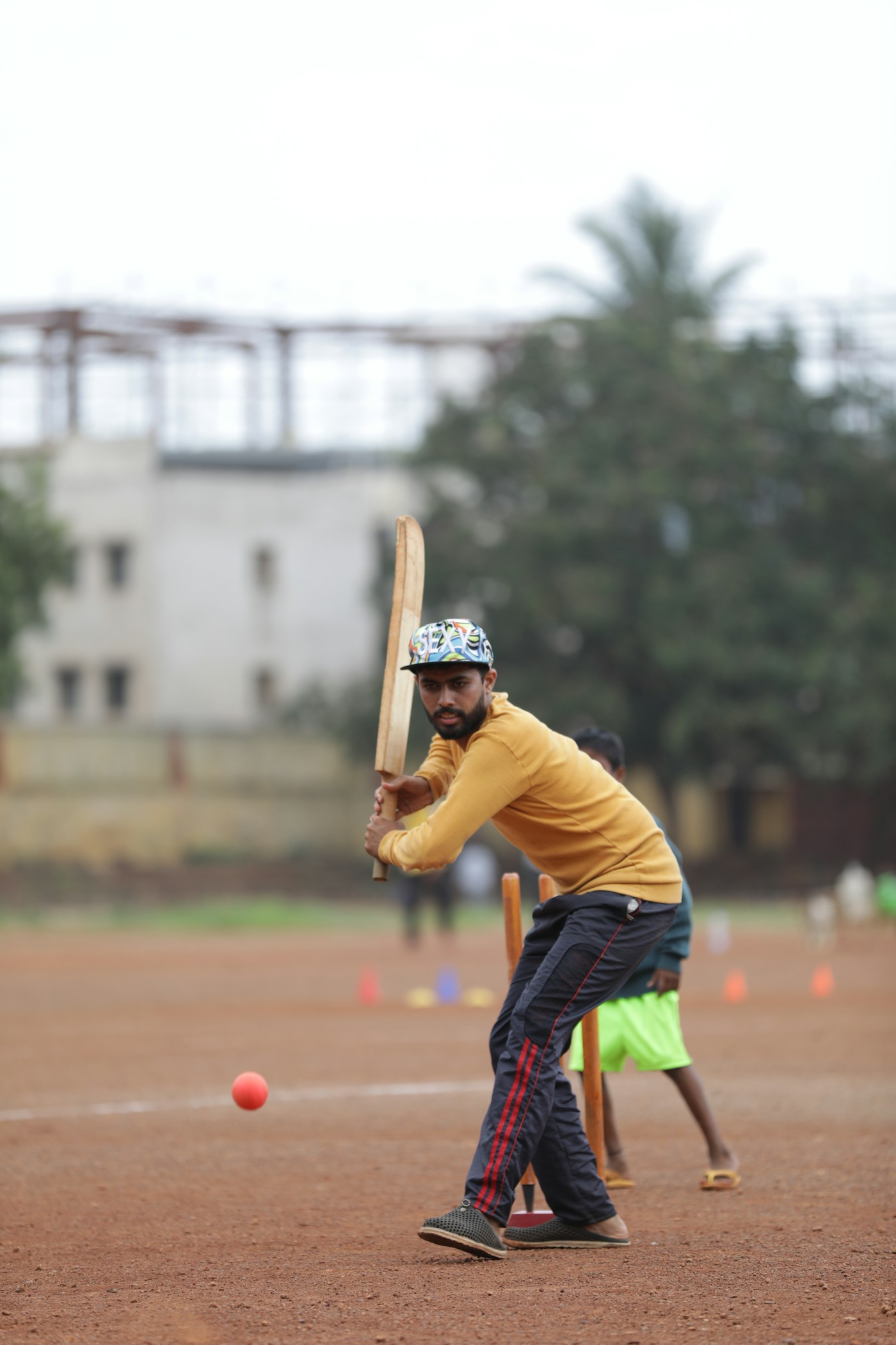 Batter playing cricket on an open ground in Hubballi